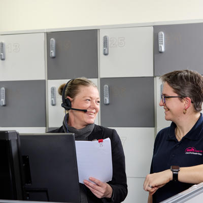 Two female Care Link Employees smiling at each other